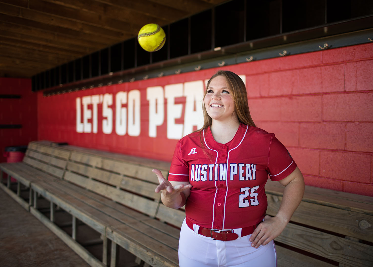 Alexis Hill poses in Softball dugout