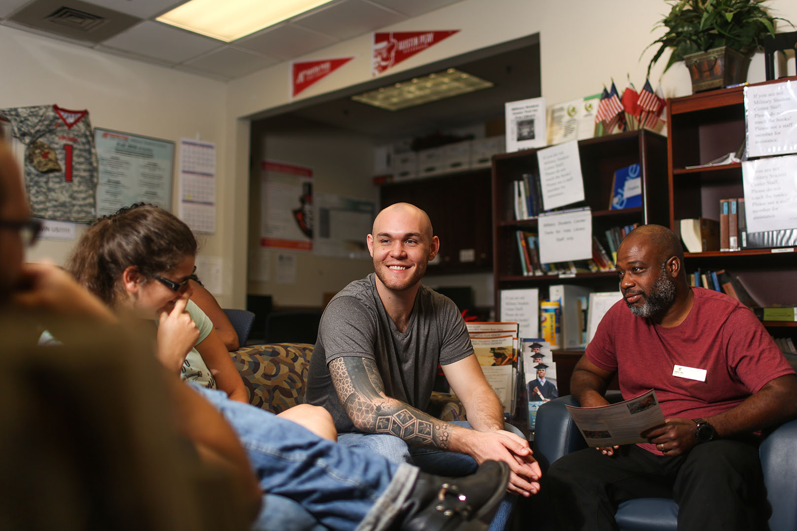 Austin Derden talks with other military students in MSC