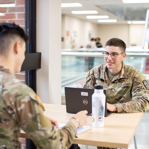 two students sitting and talking in the Sundquist Building