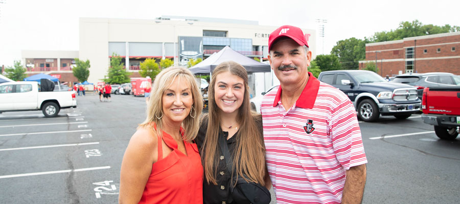 Student with their parents before the football game