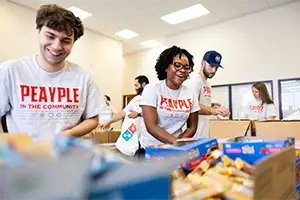 Faculty, staff, and students packing meal bags