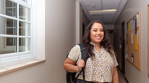 Sociology student stands in the hallways of McCord building