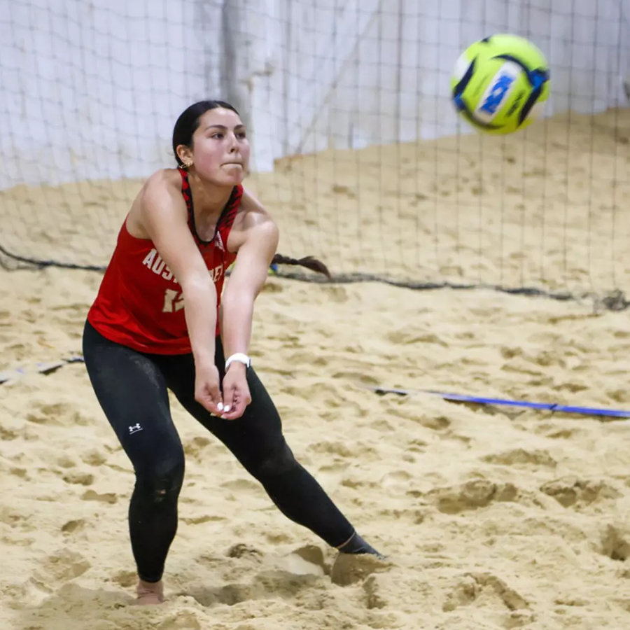 Beach vollyball player setting up to bumb the ball.