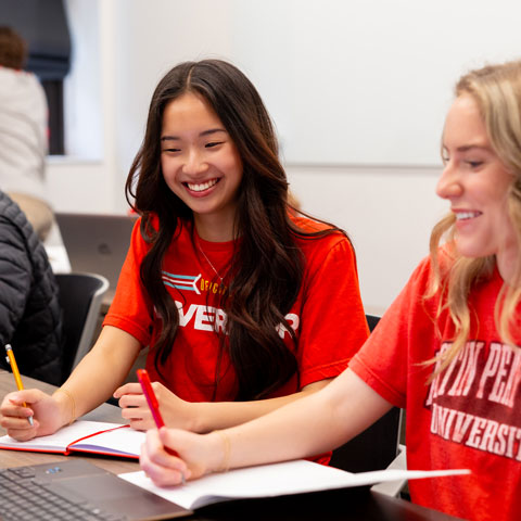 Students working and laughing together in a classroom