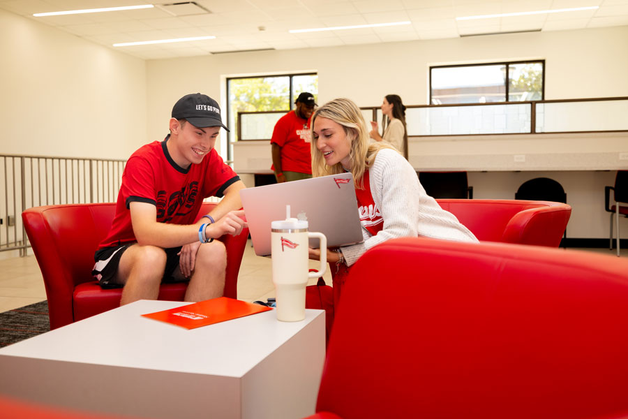 Students talking with their laptops