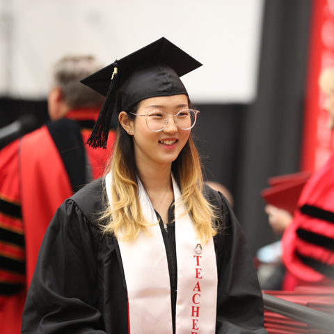 Student walking at Commencement