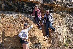 Students examine rock wall during alternative break trip