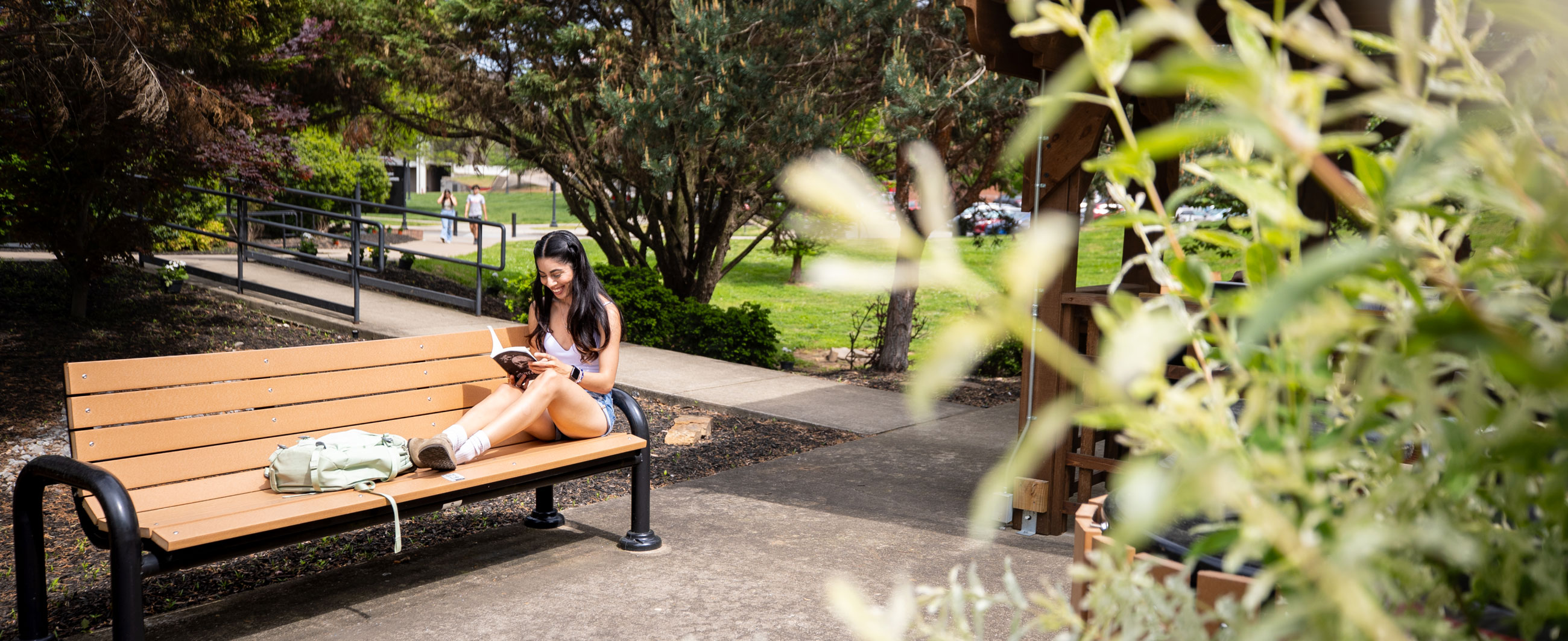 Student reading on campus