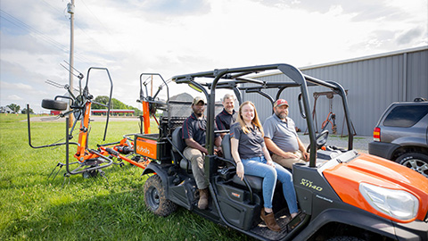 Students and professors sit in some of the new equipment for the agriculture department 