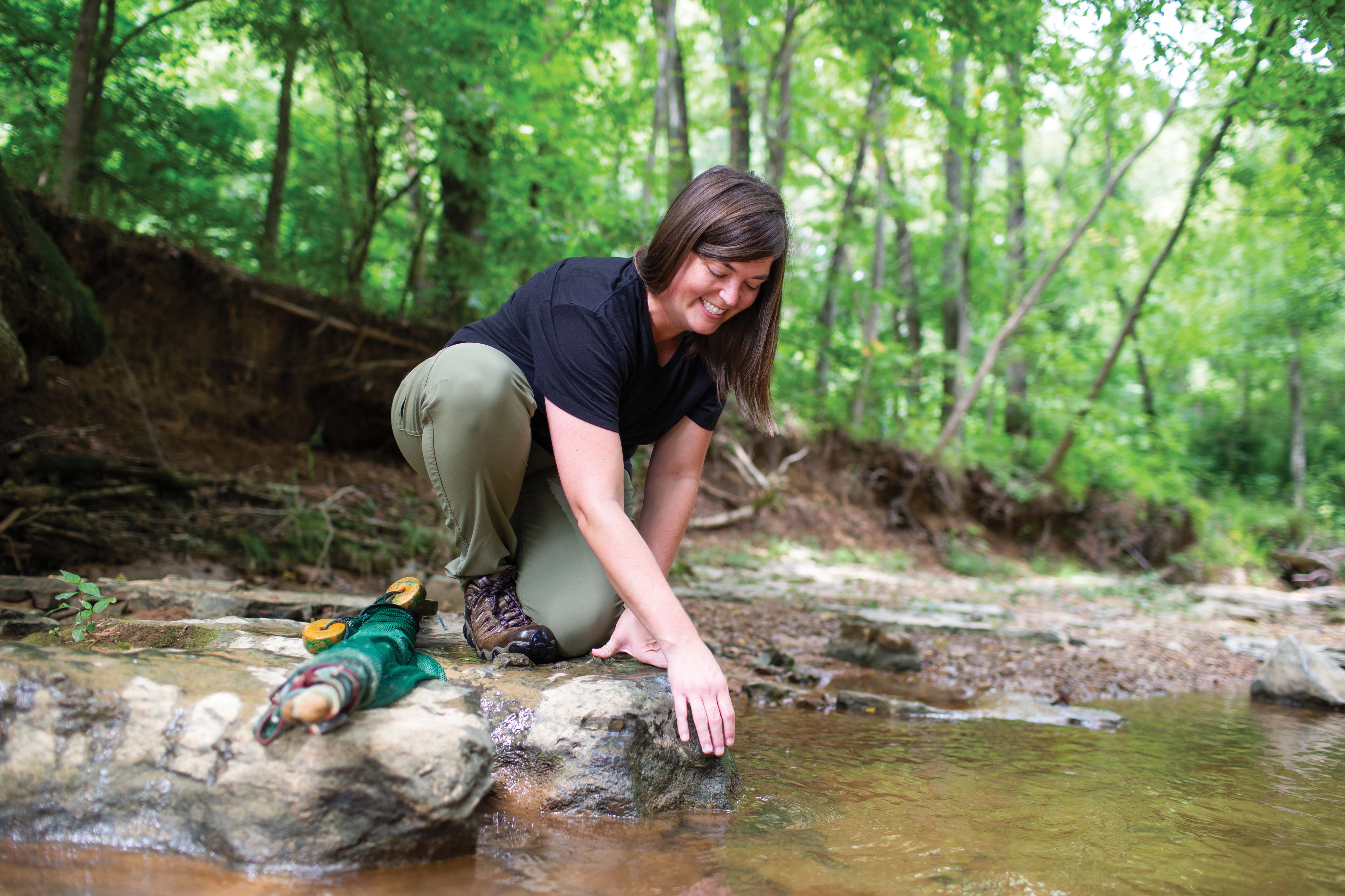 student in the creek