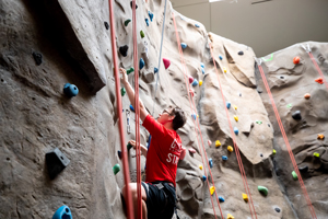 Student climbing the rock wall