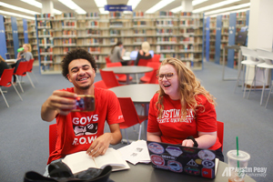 Students pose for photo in library