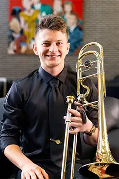Student sitting down with his trumbone