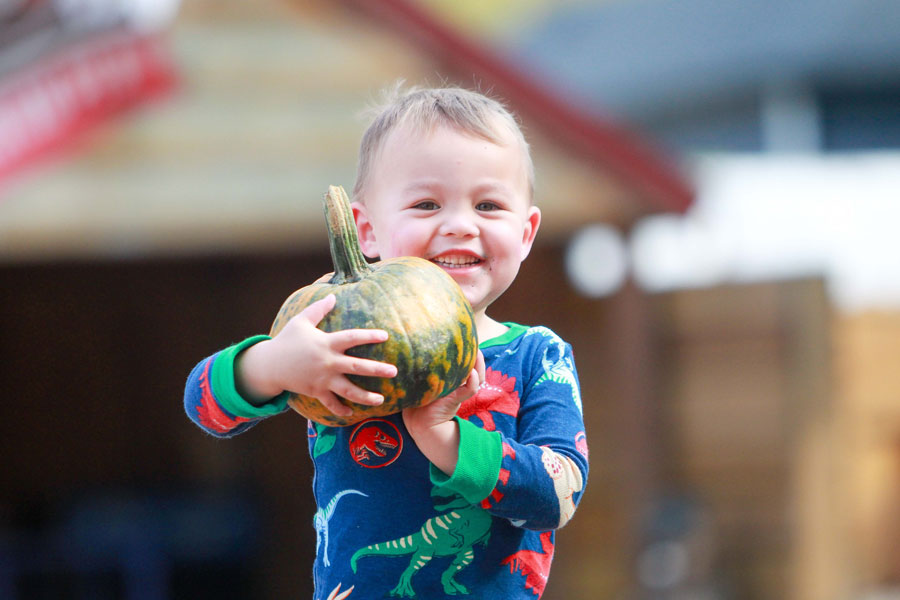 Child showing off their pumpkin