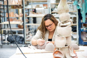 Student working with a sculpture