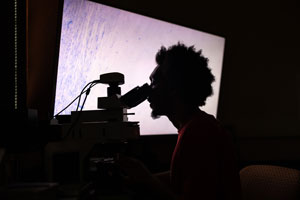 Student looking through a telescope