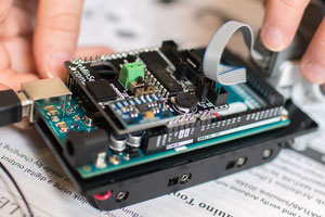 picture of hands holding up an electronic board