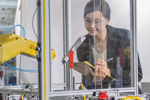 Student observing a machine