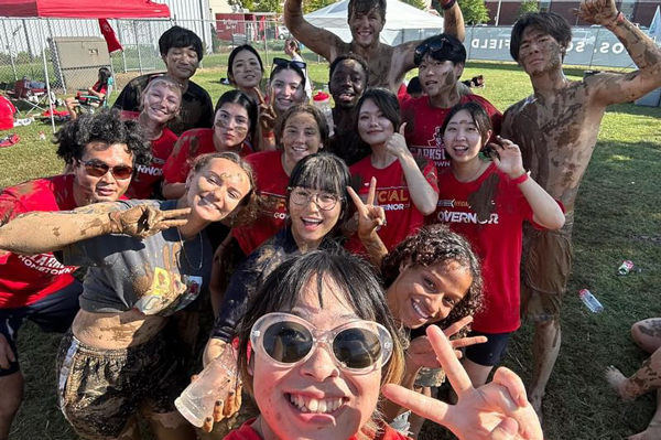 Students posing for a picture after participating in the Annual Mudbowl.