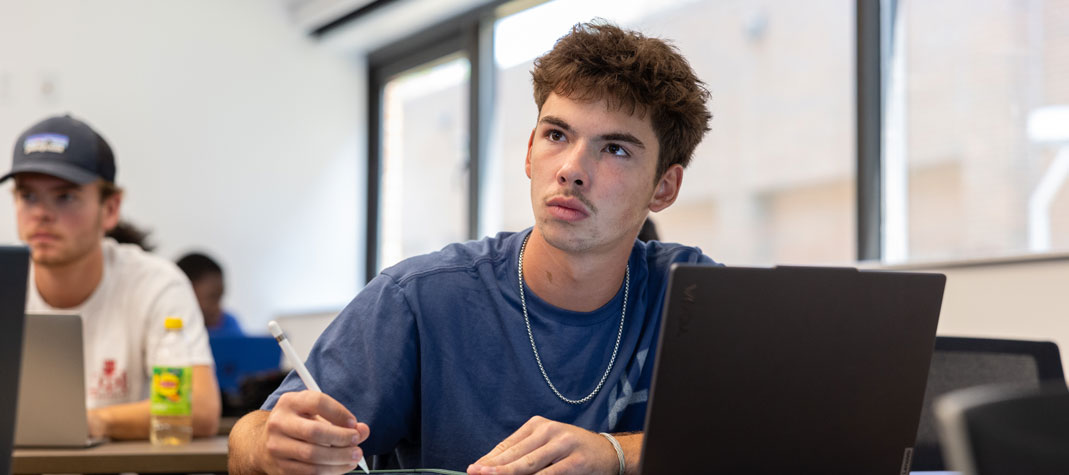 Student taking notes in the classroom