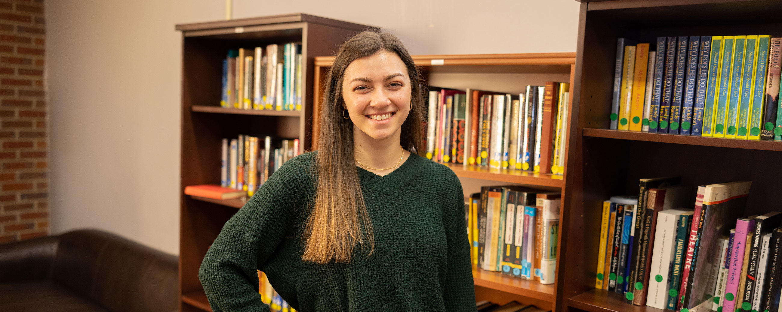 Student in front of bookshelves