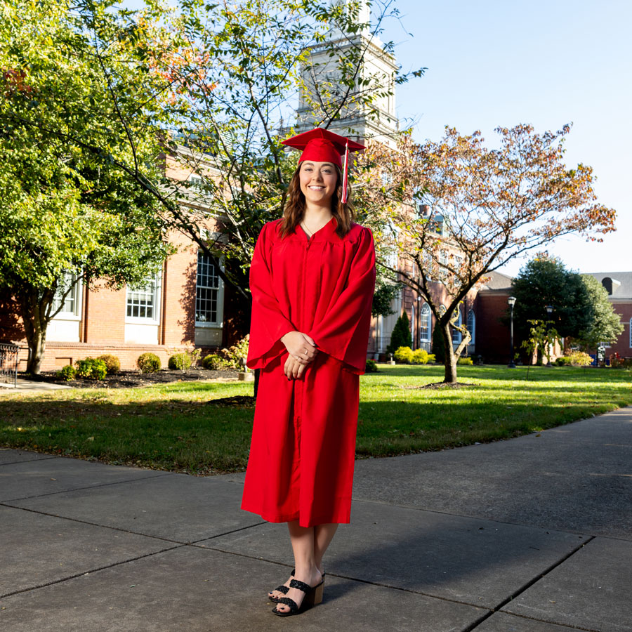 Student wearing the new red regalia for graduation