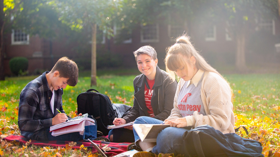 students out on the lawn on a sunny fall day.