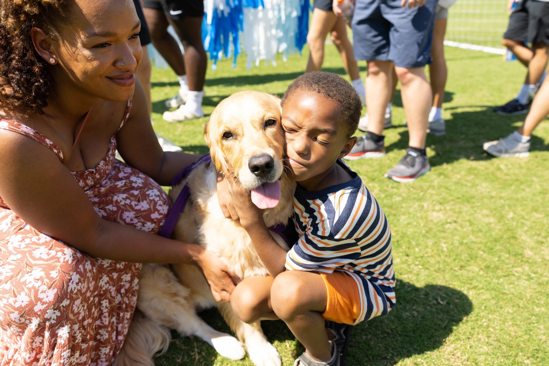 Xavier, a Make-A-Wish child and cancer survivor, with his dog Journey.