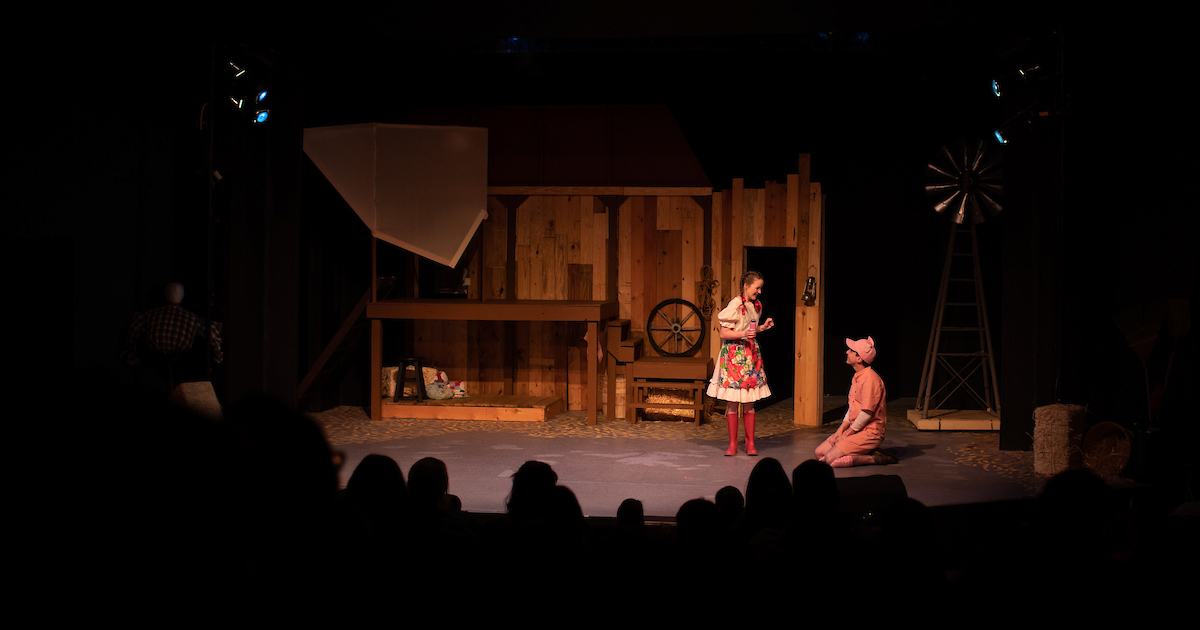 Fern (played by Kylan Elizabeth Ritchie) and Wilbur (played by Cory Clark) get to know each other at the beginning of “Charlotte’s Web” at the Roxy Regional Theatre.