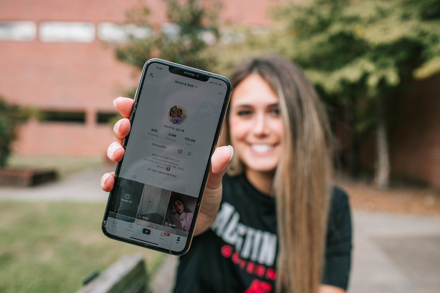 Austin Peay State University business marketing senior Jenna Pry and her brother, Seth, have become TikTok stars, attracting more than 3.7 million followers since a December 2019 video went viral.  In the eight-second video, Seth sprints through a rain-drenched parking lot in his Chick-fil-A uniform to Jenna’s car and asks, “Have you been served yet, ma’am? Can I get you anything?” That video has earned 3.6 million views so far.  From there, the brother and sister duo have carved out success from their videos, and some of their video’s costars – such as a literal throw pillow and a see-through chair – have helped propel them to stardom.  We caught up with Jenna, who expects to graduate in May, to ask how she and Seth have adapted to their fame, especially while navigating a pandemic.  How did the Chick-fil-A video happen?  I think it was the second week of last December, and it was our first video. I usually text Seth when he’s at Chick-fil-A and ask him to throw some extra nuggets in just to let him know I’m there. He was actually sitting in the parking lot waiting for his shift to start, and I texted that I was in the drive-thru and saw him. I’ve always recorded stuff and just leave it on. I have so many videos of him when he was younger. He’s always been so goofy. And I just happened to flip on my camera, and he was running, and it blew up. That was not planned. It just happened so fast.  How quickly after the video went viral did you figure out you could just keep making popular videos?  After that Chick-fil-A video we really didn’t know how to style videos people liked because it was just such a spontaneous video. I didn’t know how to keep rolling with this. The next few videos kind of didn’t do so well because we didn't really know what we were doing. Then I don’t know, I guess people just fell in love with Seth’s character, and we just kept going with it.  How do you come up with the ideas for your videos?  Some of our ideas are planned but most of the time, I just tell Seth to walk through the door and say something dumb because he’s really good at that. But, yeah, our scripts are very spontaneous. We just go with it. We don’t script much.  But you do stick to some themes?  Yes. We do stick to opening the door and throwing the pillow. Seth pretty much just says whatever. We have the same routine.  Even though you’re mostly behind the camera in your videos, your laughing in response to your brother is part of the magic of the video.  Yeah, people say my laugh is contagious and that they like to laugh along with me.  What was your life like during the next several months?  Me and Seth both have jobs, and it was kind of hard to fit our time in with all that craziness going on. Making videos was extremely hard from December to March. Then in March, me and Seth both got relieved from our jobs, and that’s when we started making lots of videos and hit 2 million followers. We were just doing nothing but making videos. When we both got back into our jobs, things started slowing down again, but I recently quit my job. Sometimes we struggle here and there, like he wants to go and do his thing and I go and do my thing. He’ll come home at midnight, and I’ll say, “All right, let’s do video real quick.”  Did your videos change when the pandemic started?  Not too much. Our views went up a whole lot. The pandemic got everyone on their phones. We saw a huge increase in our engagement  Tell me a little bit more about yourself outside the videos.  I’m a military brat originally from Georgia. I came to Austin Peay because my family is local, and I wanted to stay with my family. I wanted to go to a bigger school, but I’m glad I go here because it’s smaller, I’m with my friends, and the classes have 20 people, so I’m able to connect with my professor. Seth is studying to be a pilot. He gets his license at the end of this month. He wants to get his license then go fly commercial. He’s wanted to do that since he was young.  To see more  You can see more of Jenna and Seth’s videos on their social media accounts:  • TikTok: @jenna_pry. • Instagram: @seth.pry. • YouTube: Jenna and Seth Pry.  This interview was edited for length and clarity.