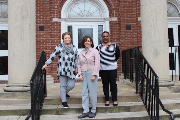 Nursing faculty pose in front of McCord