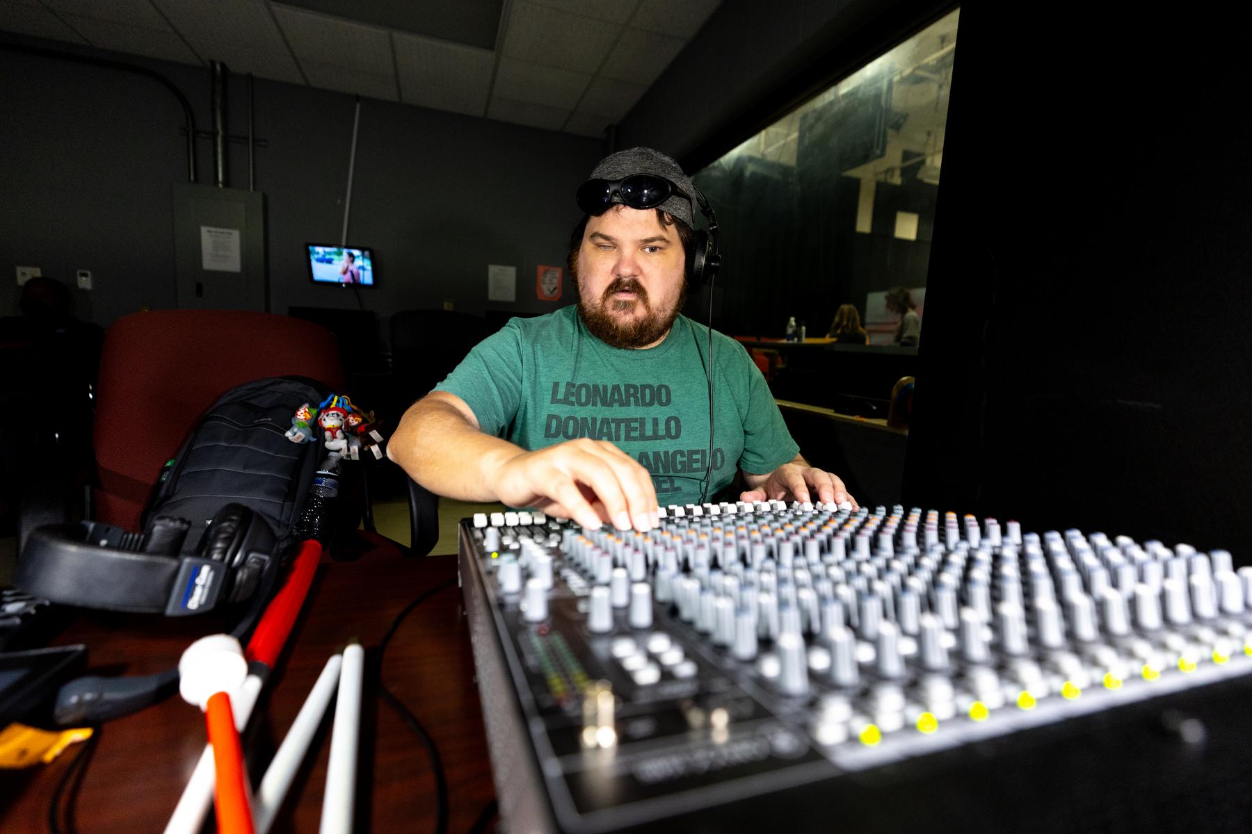 Freshman sports communication major Joseph Brock operates equipment in WAPX-FM's studio.