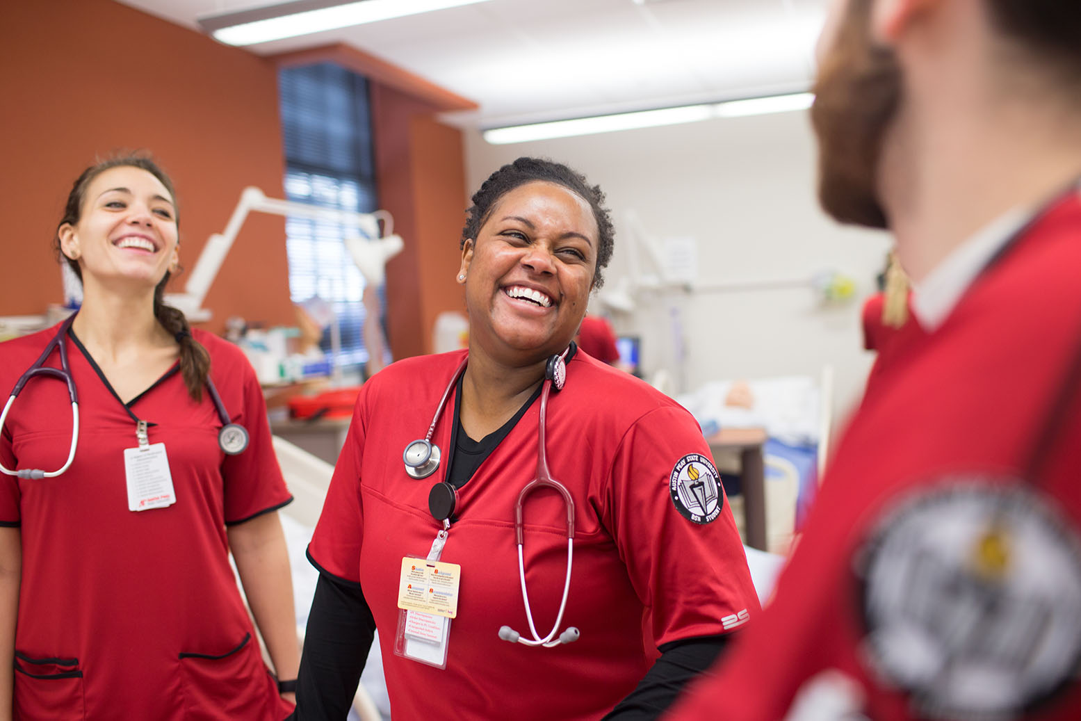 Nursing students laugh in lab