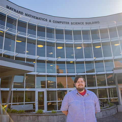 Computer science student in front of Maynard