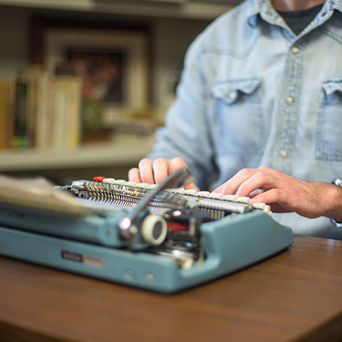 Conor Scruton writes poetry on typewriter in library