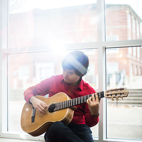 René Villareal plays guitar in Morgan University Center