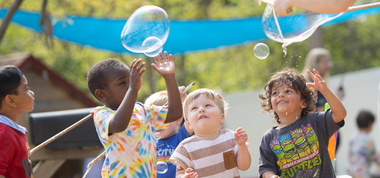 Children playing with bubbles at the Child Learning Center