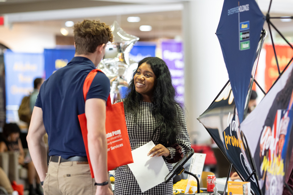 Student talking to recruiter at an employment fair