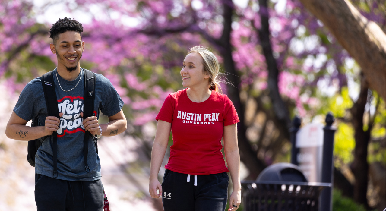 Students walking on campus during the spring